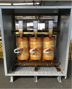 Three-phase 750KVA transformer with copper windings and electrical components mounted in industrial enclosure
