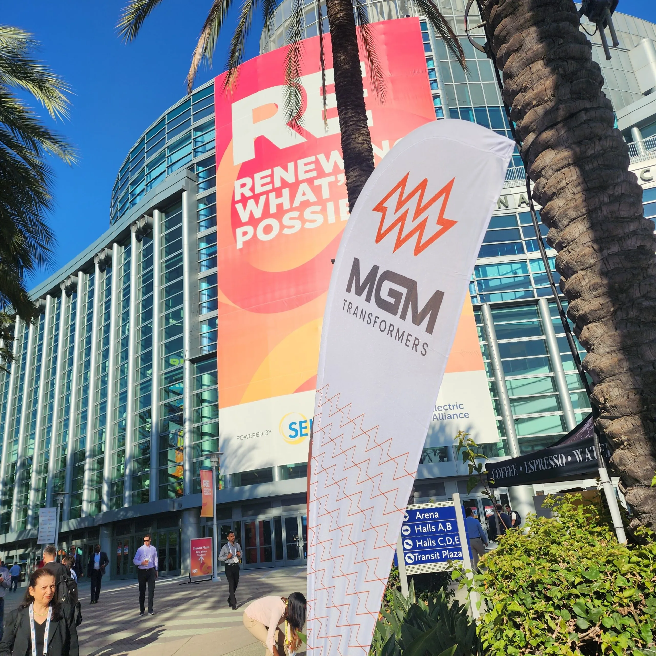 MGM Transformers banners displayed outside convention center with palm trees and "Renew What's Possible" messaging
