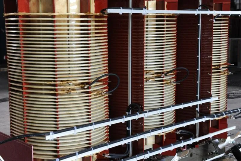 Industrial transformer coils with copper windings and red core frame in MGM Transformers product gallery