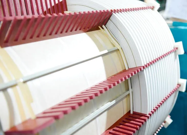 Layered red and white corrugated transformer core components stacked showing industrial manufacturing precision