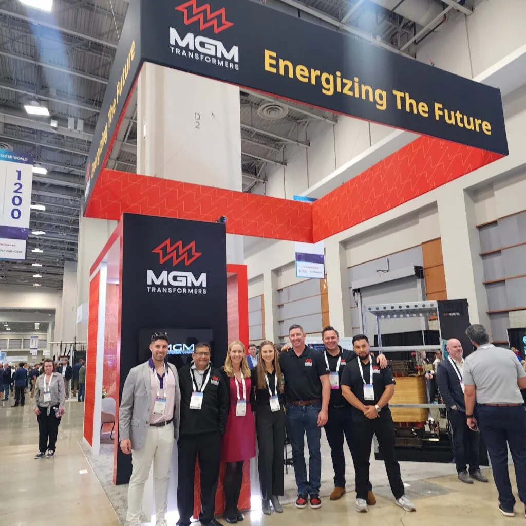 MGM Transformers booth at Data Center World 2025 with team members and red "Energizing The Future" signage