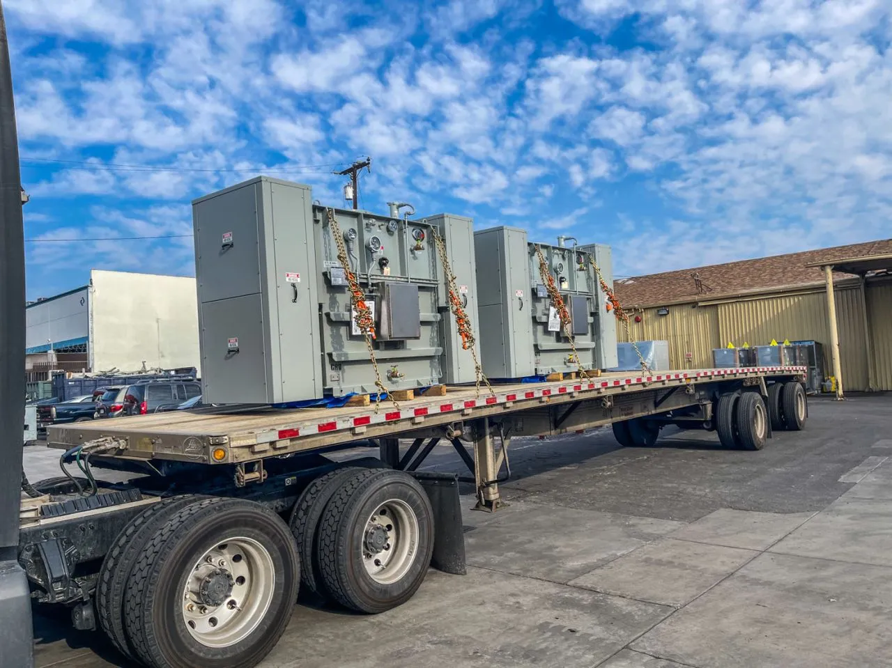 Large substation transformers loaded on flatbed trailer for delivery to energy provider